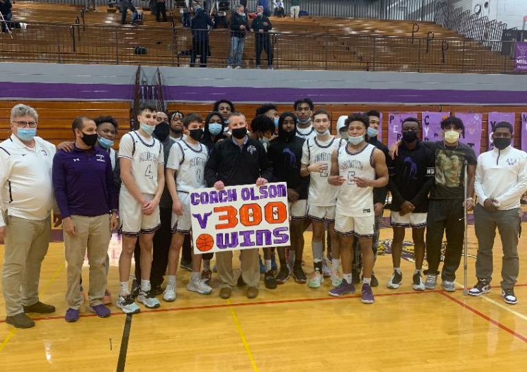 The Boys Basketball team celebrates Coach Olsons 300th win.