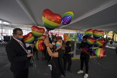 Mexican civilian registration office workers decorate with heart-shaped, rainbow colored balloons for a same-sex mass wedding ceremony.