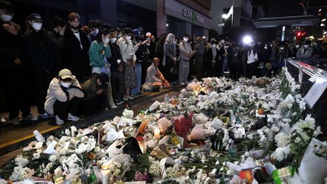 People gather to pay respects to the lost lives in the Seoul crowd crush