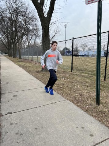 Jack Strilky runs down the sidewalk during a track practice. 
