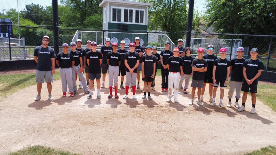 Members of the Niles North baseball team pose with young aspiring baseball players. 