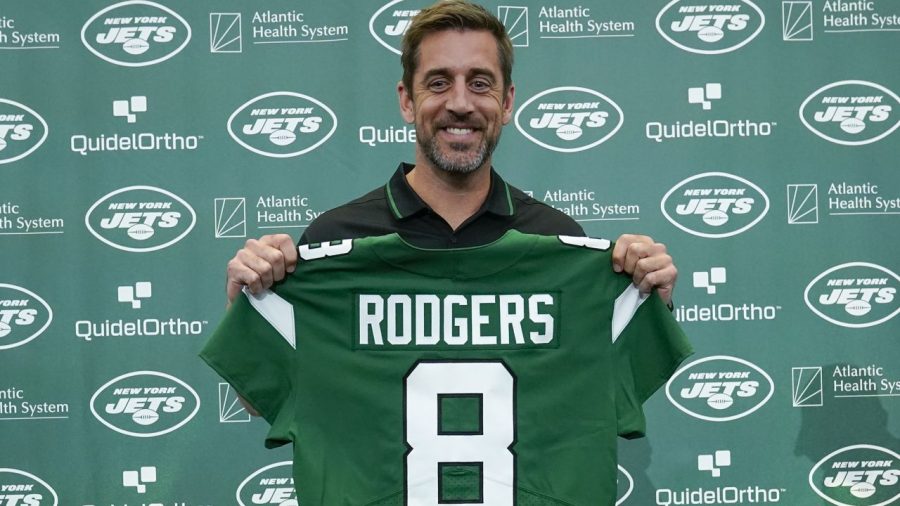Rodgers poses with his new number for the New York Jets.