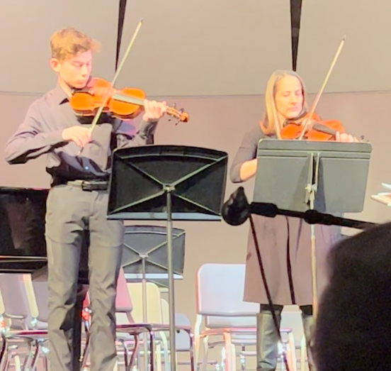 Orchestra teacher Jennifer Page and student Azi Altgold show how music is a symbol of hope.