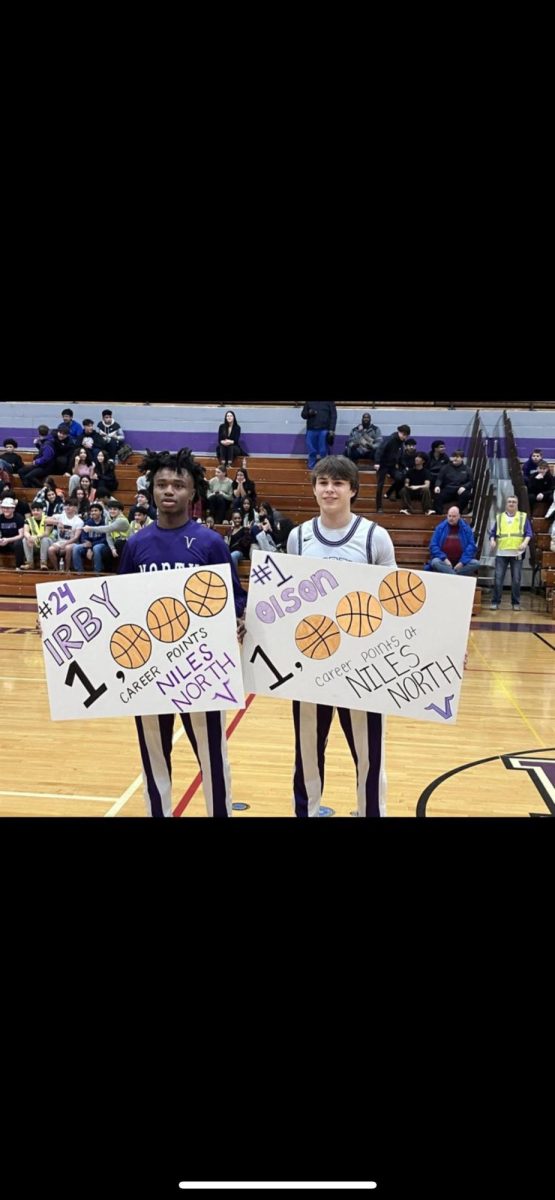 Juniors Yaris Irby and Reid Olson hold posters celebrating their achievements. Photo credited to: Niles North Athletics on X