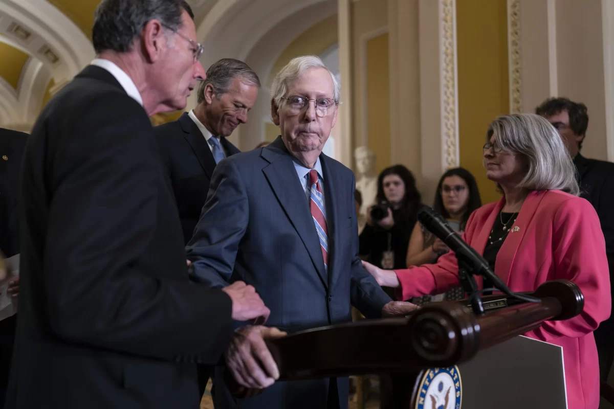 Senate Minority Leader Mitch McConnell s helped after the 81-year-old GOP leader froze at the microphones as he arrived for a news conference, at the Capitol in Washington, Wednesday, July 26, 2023.
