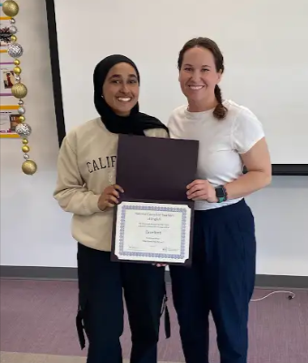 Junior Asmaa Khan and English teacher Ashley Amelianovich celebrate because Khan has been selected for a 2024 Achievement Award in Writing, given by the National Council of Teachers of English.