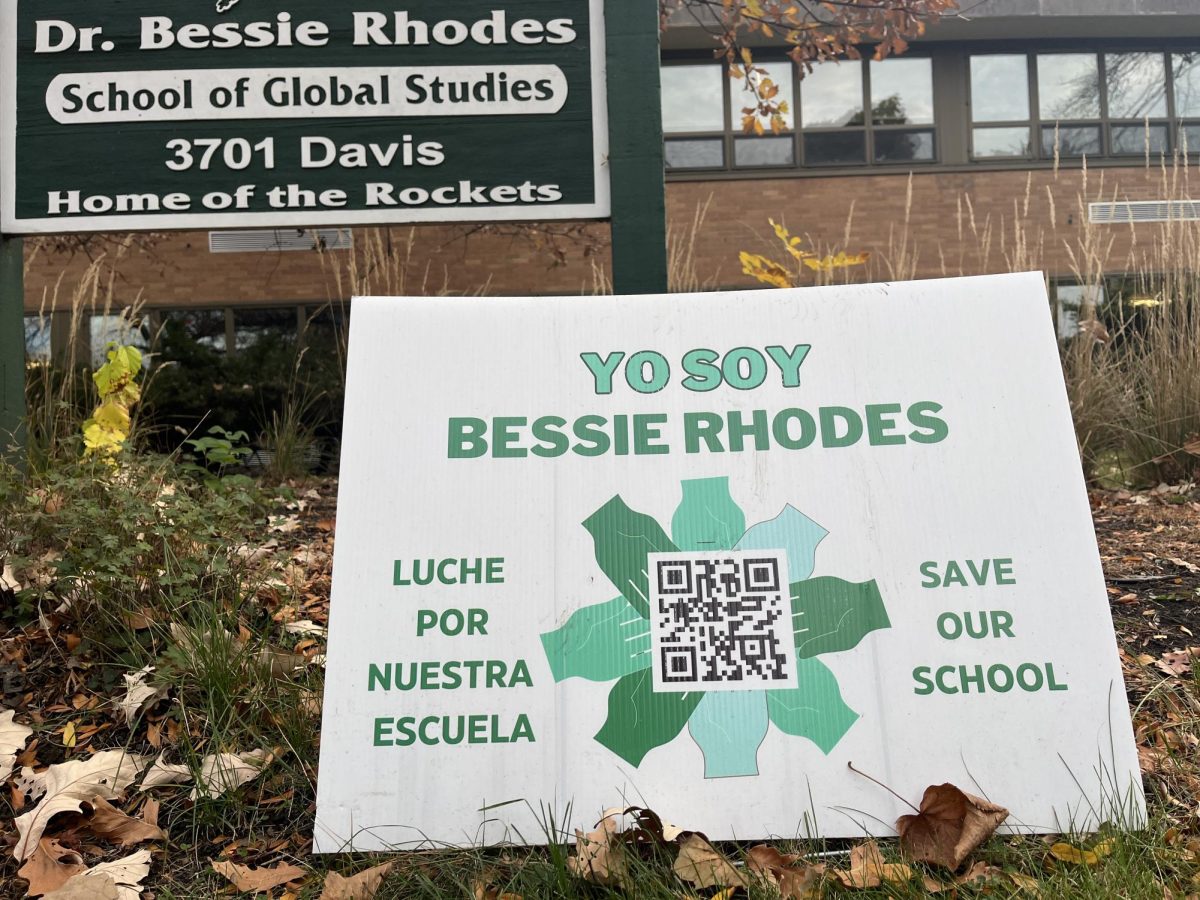 A yard sign posted outside the Dr. Bessie Rhodes School of Global Studies, protesting the school's planned closure following the 2025-2026 school year. 