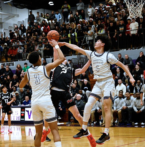 Dylan Lam (right) playing lockdown defense against Niles West during last year's crosstown classic.