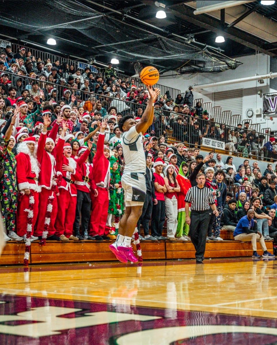 Senior Andy Simon pulling up for three during the Crosstown Classic on Dec. 6.