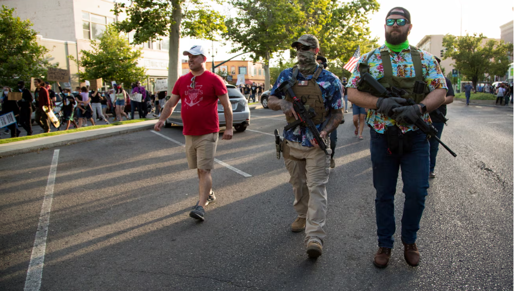 Militia members walking beside a protest in Utah in 2020.