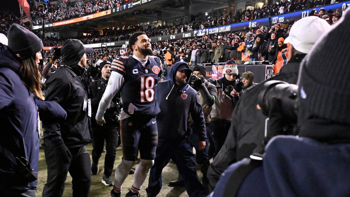 Bears quarterback Caleb Williams walking through swaths of fans and media after the Bears 31-27 victory over the Packers